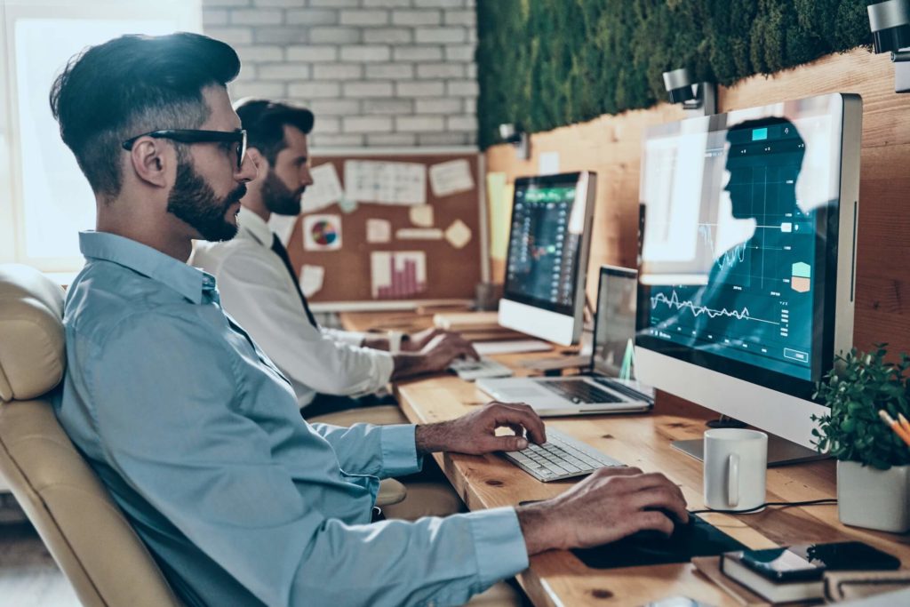 two men in front of computers