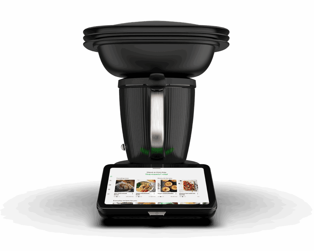 Front view of Thermomix TM7 all-in-one kitchen appliance in matte black with integrated touchscreen showing recipe interface