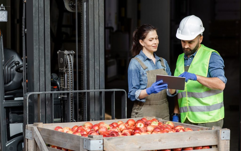 Agritech workers managing the supply chain and logistics of products in modern agricultural business
