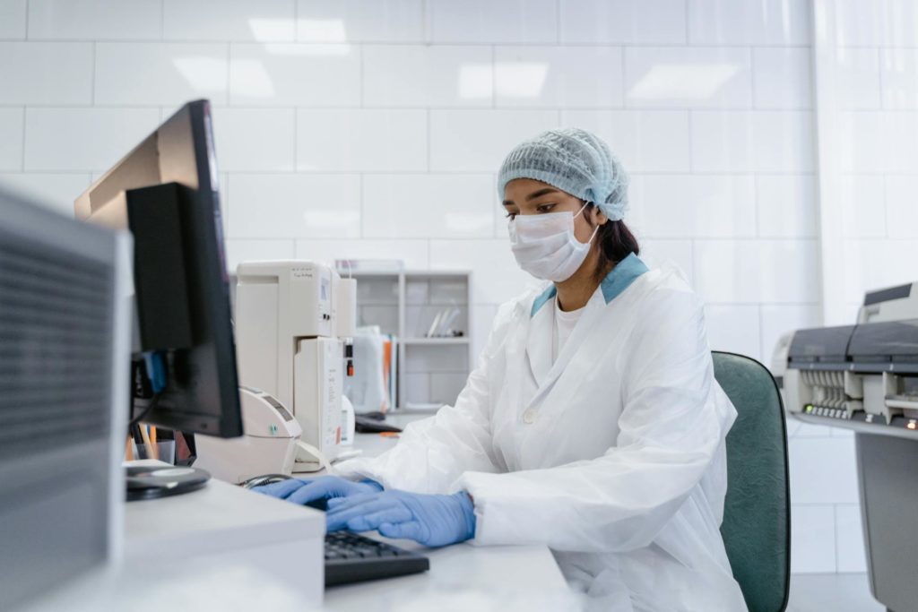 A woman sitting by the desk, working in a chemical plant