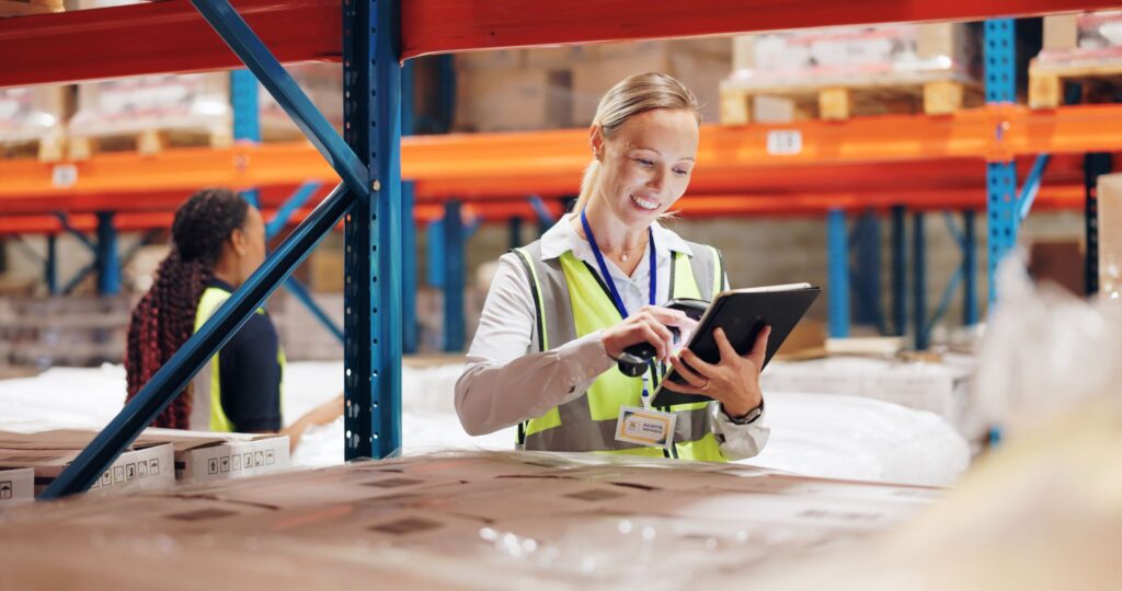 Woman scanning boxes in warehouse for ecommerce ERP system. Development and integration of online sales systems for ecommerce.